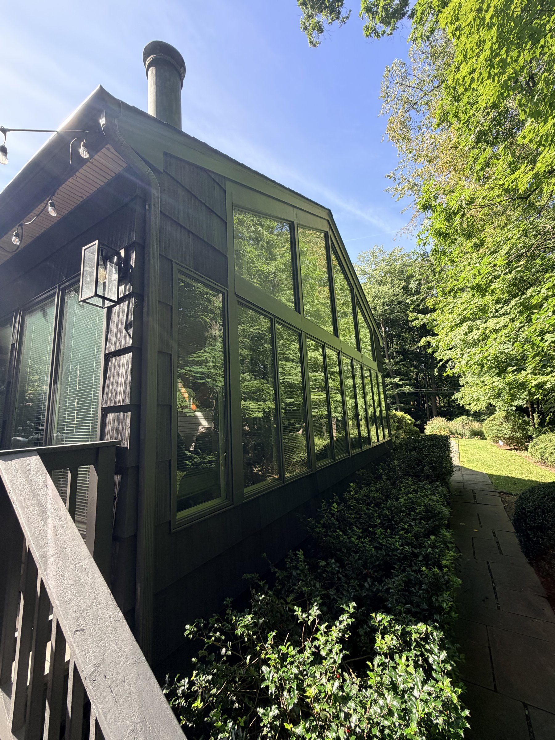 Side of the charcoal house with tall windows and ornamental grasses
