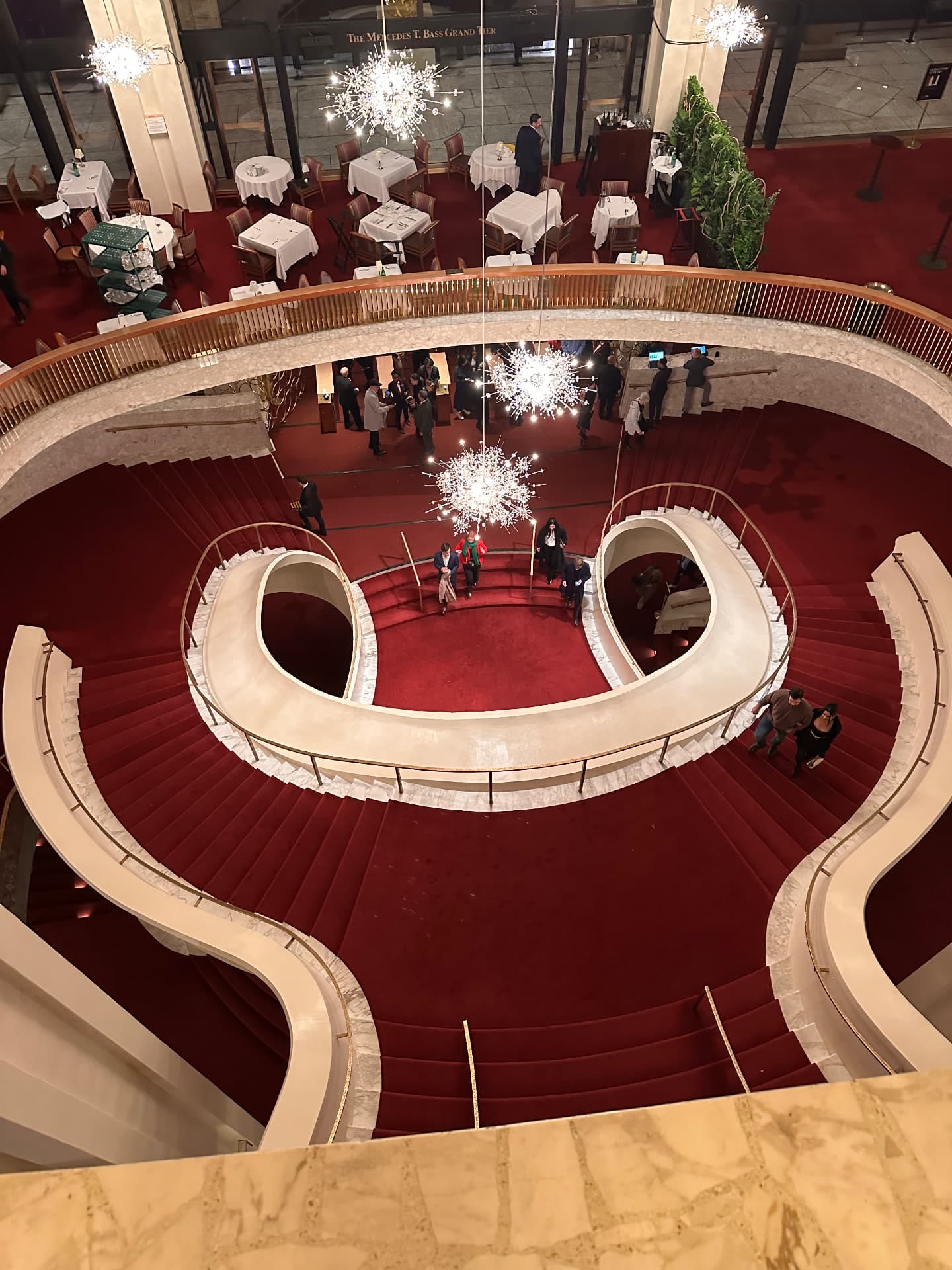 Looking down on the curving red-carpeted staircases and starburst chandeliers inside the Metropolitan Opera House